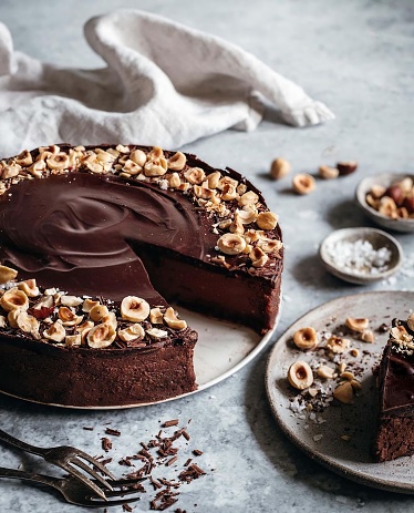 Coconut cake with chocolate topping named Ruske kape on a plate on dark table