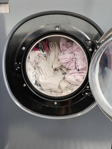 istock Washing clothes at a laundrette 1454762874