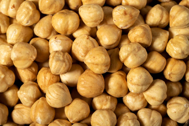 istock Roasted hazelnut nuts on dark background. Many delicious nuts as background. Studio shoot. Top view 1454764850