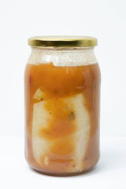 istock Glass jar of stuffed cabbage tomato sauce isolated on a white background 1454765129