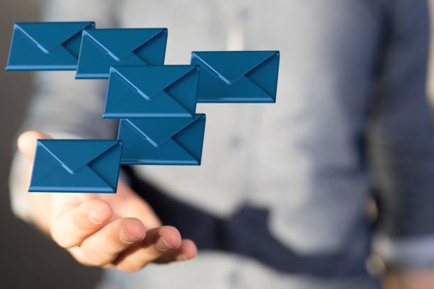 istock 3D render of an email symbol and Network Communications with a male hand on a blurred background 1454767297