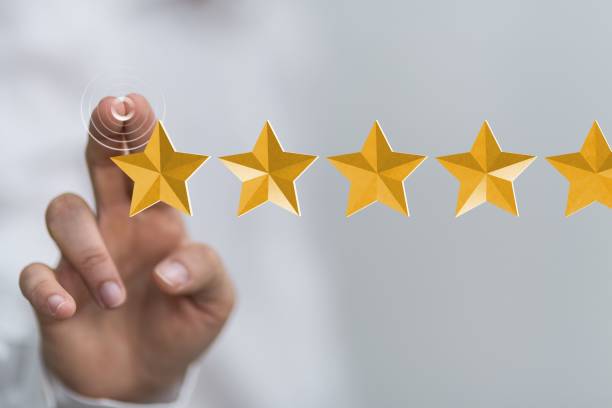 istock Person presenting a virtual projection of a five star rating 1454767946