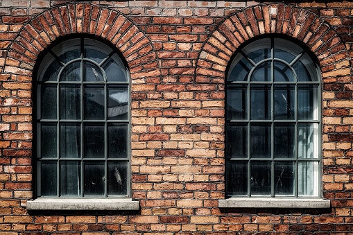 A couple of arched windows on a former factory building in Norrkoping, Sweden