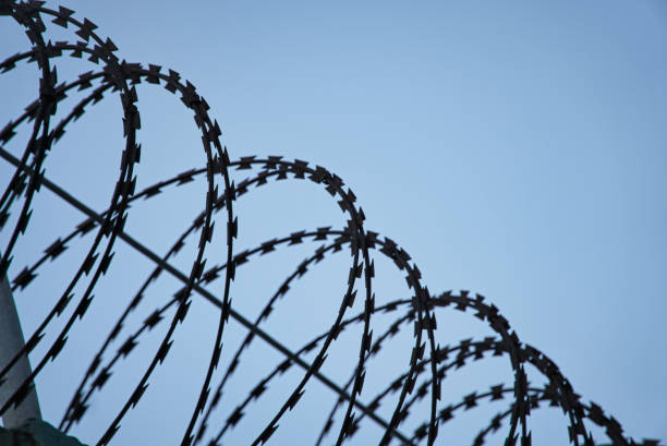 istock Circular metal fence against blue sky background 1454772632