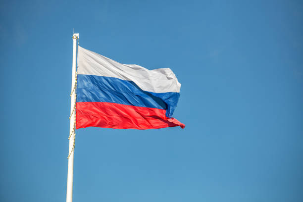 Flag of Russia is waving against the background of a clear cloudless sky