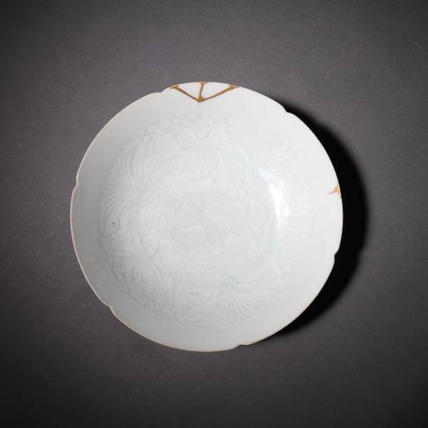 istock Chinese ancient traditional decorated plate on a grey background 1454774463