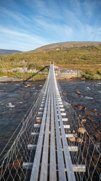 istock Norway wooden bridge with river and mountain landscape 1454774931
