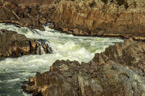 A scenic view of a river flowing over the rocks