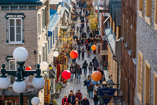 Quebec, Canada - October 23 2022 : Tourists shopping on the Quartier du Petit Champlain street. Quebec City Old Town in autumn.