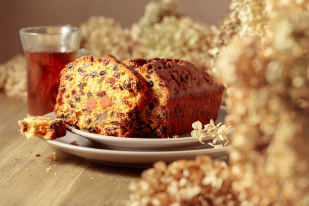 istock Fruit cake and tea on a wooden table with dried flowers. 1454777320