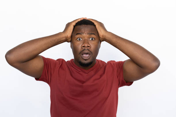 istock Amazed young man holding his hands on head from shock 1454777489