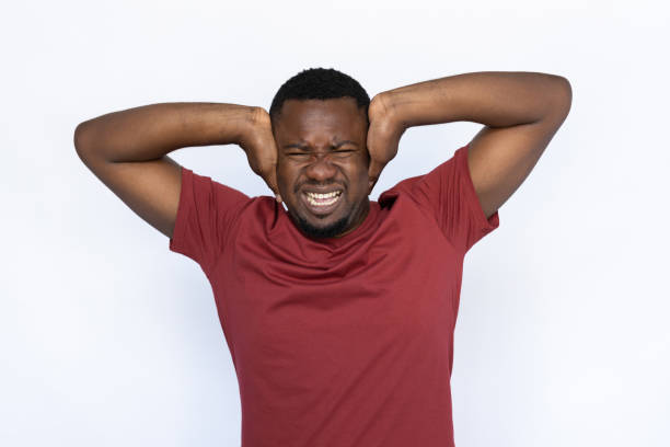 istock Irritated young man covering his ears 1454777547