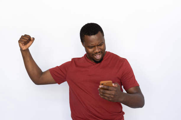 istock Satisfied young man looking at smartphone screen 1454777555