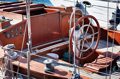 Yacht wooden deck and steering wheel old retro vintage