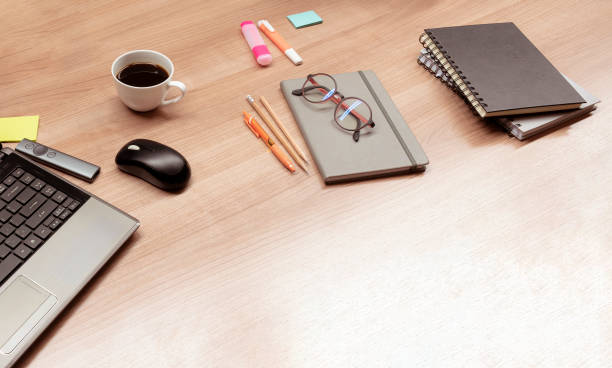 istock Top view laptop and coffee and accessories on table 1454777840