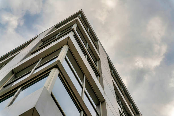 istock Low angle shot of a business building under the cloudy sky 1454779849