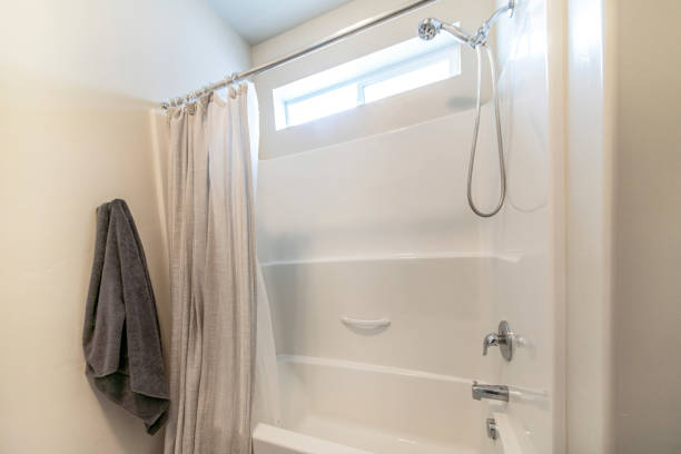 istock Bath tub with curtains in a bathroom 1454779874