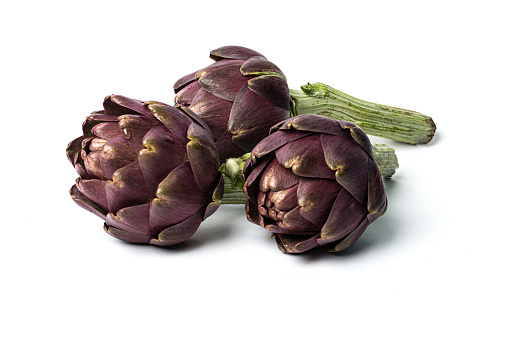 Three artichokes on white background.