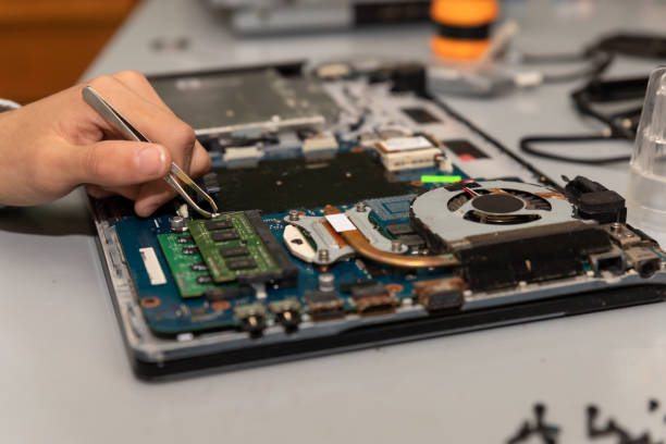 istock Computer repair technician repairing a laptop 1454780862