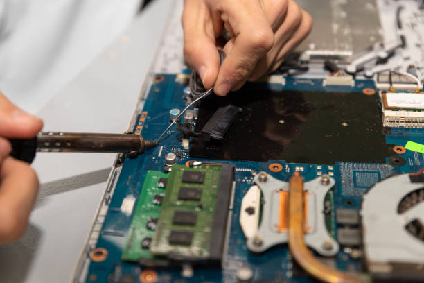 istock Computer repair technician repairing a laptop 1454780874