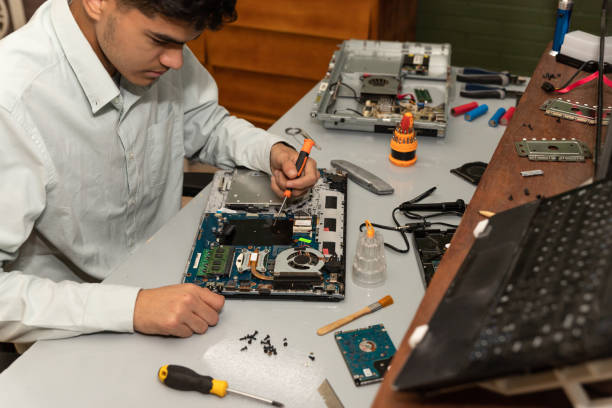 istock Computer repair technician repairing a laptop 1454780888