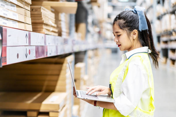 istock Engineer woman check stock details on tablet computer for checking boxes with logistics on shelves 1454782197