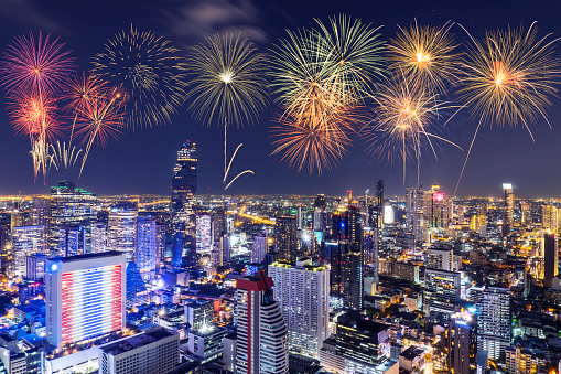 New Year colorful fireworks with cityscape bangkok skyline in night time, height building for business stand in the heart of Bangkok,Thailand.