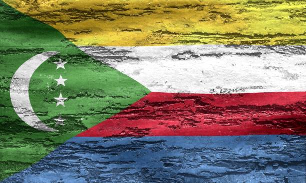 istock Comoros flag printed on a textured chipping wood background 1454782907