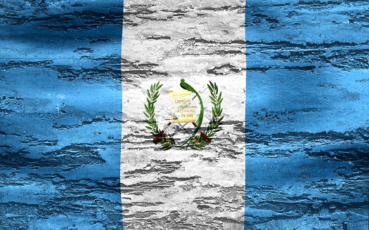 A Guatemala flag printed on a textured chipping wood background