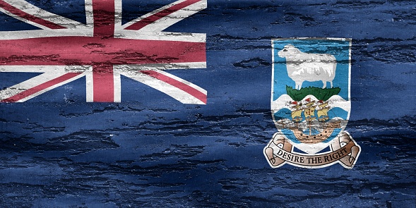 A Falkland Islands flag printed on a textured wooden background