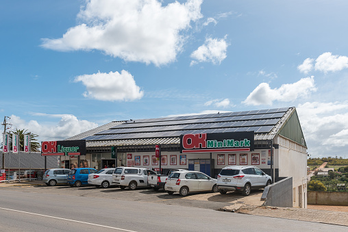 Napier, South Africa - Sep 23, 2022: A street scene, with a supermarket and vehicles, in Napier in the Western Cape Province. Solar panels are visible
