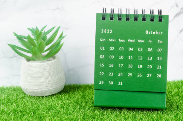 The Green October 2023 Monthly desk calendar for 2023 year on grass. stock photo