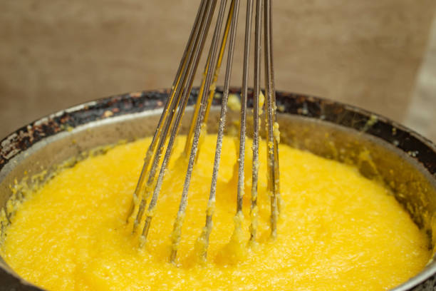 istock Boiling corn flour in a cast iron pot, making mamaliga 1454793416