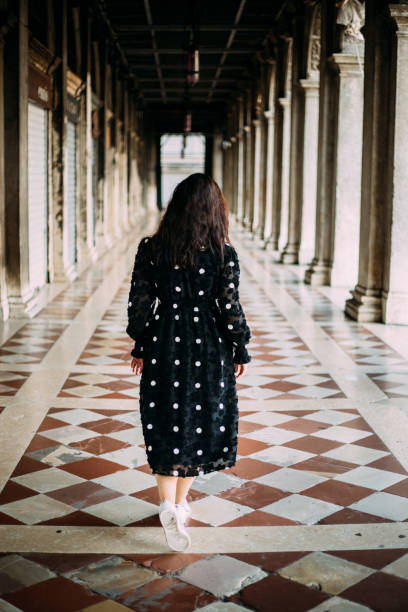 istock Woman with dotted dress exploring venice 1454794782