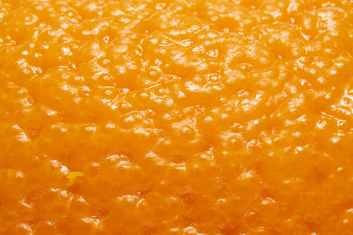 Extreme close up on the texture of orange skin peel