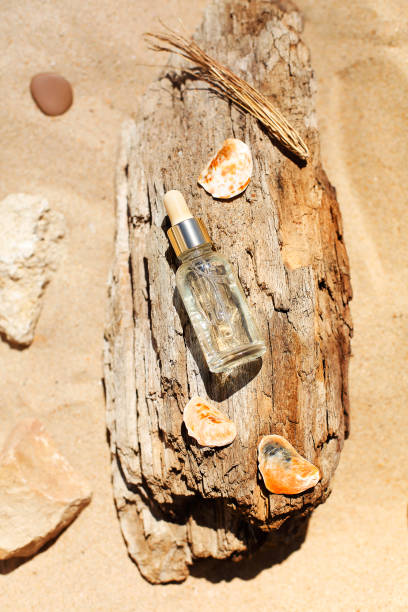 istock Essential oil on wood on beach 1454795942