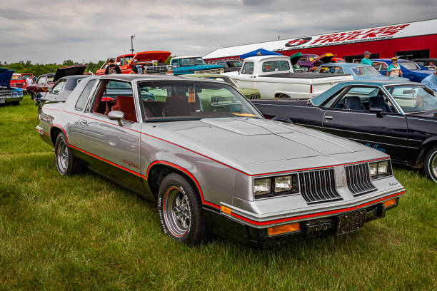 Iola, WI - July 07, 2022: High perspective front corner view of a 1984 Oldsmobile Hurst Olds Cutlass Supreme Coupe at a local car show.