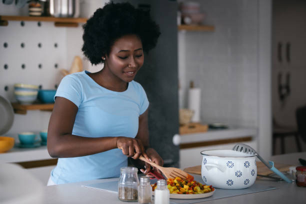 istock Housewife preparing meal in her kitchen. 1454799125