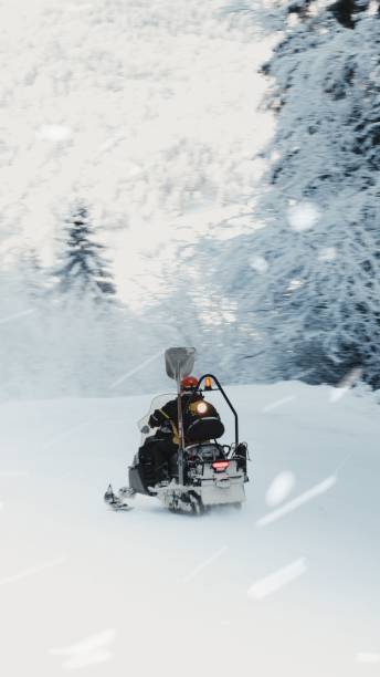istock Tourist riding a snowmobile on a snowy field during winter 1454801313