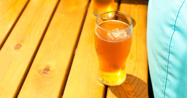 istock Beer in glasses on a wooden beach table. Blue pillows. Summer relaxation and rest from worries. Copy space for text. 1454802437