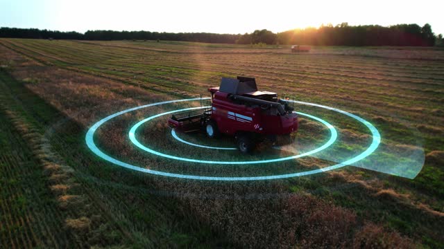 Self-driving autonomous harvester scans farm field during harvesting. Hybrid electric combine with hud elements, aerial view, motion graphics elements. Future technology with smart agriculture farming