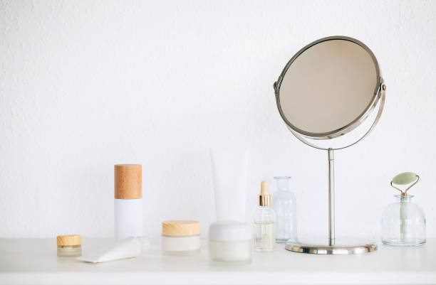 istock Cosmetic products and mirror on table 1454803691