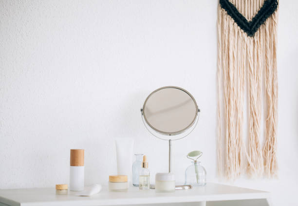 istock Cosmetic products and mirror on table 1454803702