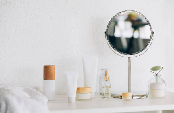 istock Cosmetic products and mirror on table 1454803737