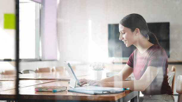 Young woman working alone at home office. freelancer using laptop computer at office. Young woman working alone at home office. freelancer using laptop computer at office. Small Business Coach stock pictures, royalty-free photos & images