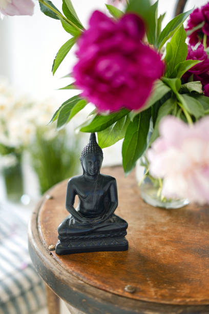 istock Black stone Buddha Figure On cozy light room background 1454804008