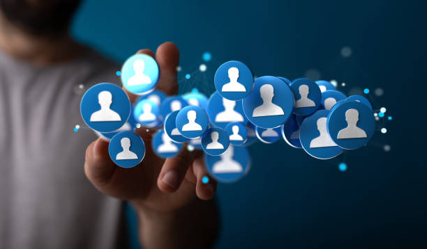 istock Man's hand tapping on 3d rendered profile icons 1454804125