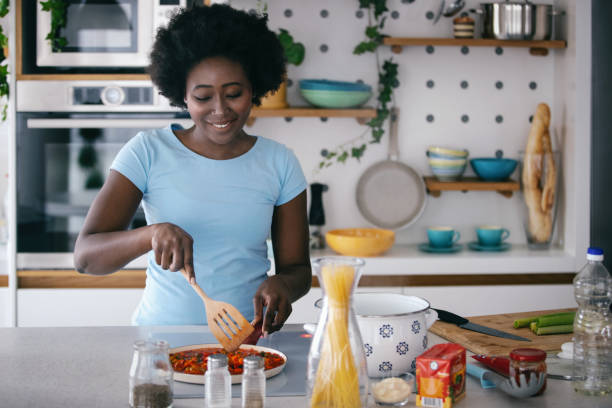 istock Housewife preparing meal in her kitchen. 1454804154