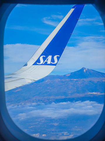 Teide volcano through the SAS airplane window. Highest mountain in Spain located in Teide national park in Tenerife