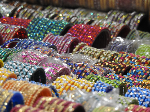 close up of sparkling colourful glass bangle display for sell